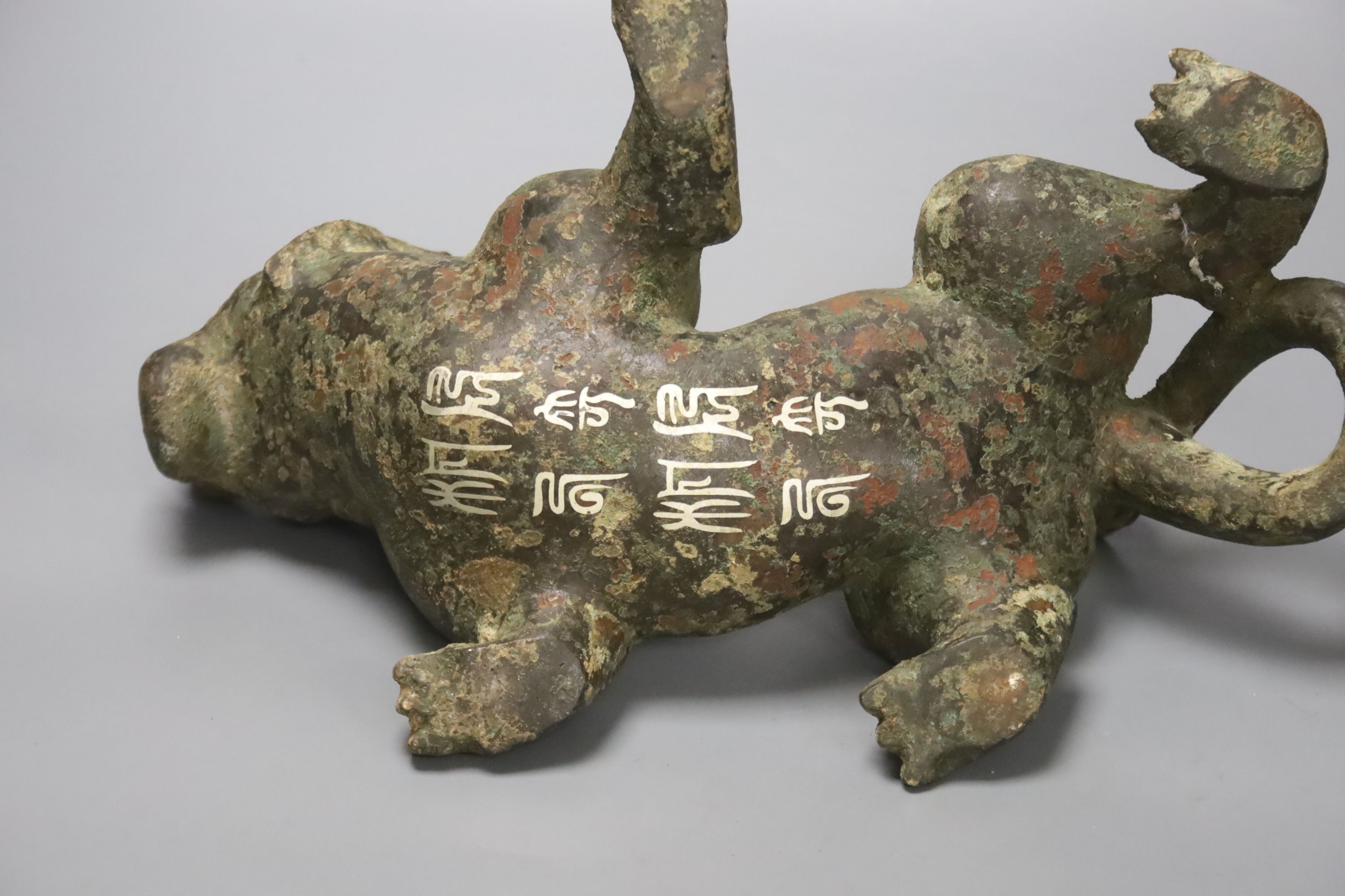 A Chinese inlaid bronze figure of a lion dog, Han dynasty style